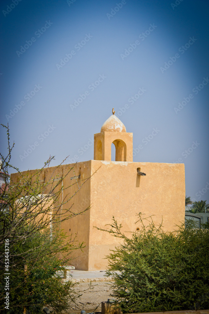 Historic arabic buildings, Barzan Watch towers made from Limestone and coral stone against a blue sky. Qatar, Middle East, no people.