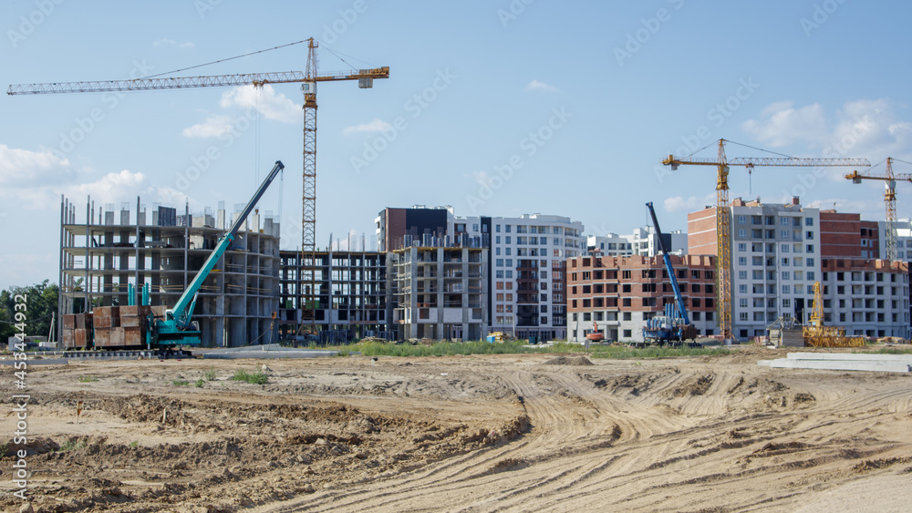 Large construction site. The process of capital construction of a high-rise residential complex. Modern residential building. Concrete building, construction, industrial site.