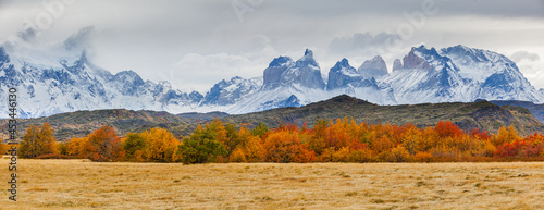 Panoramic image of an autumn landscape in the mountains: the Paine mountain range with the jagged peaks of Los Cuernos in southern Chile