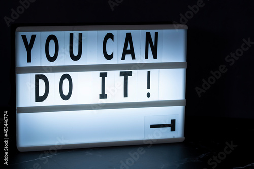 A lightbox with text You can do it! with the letter Y dropped. Motivational concept