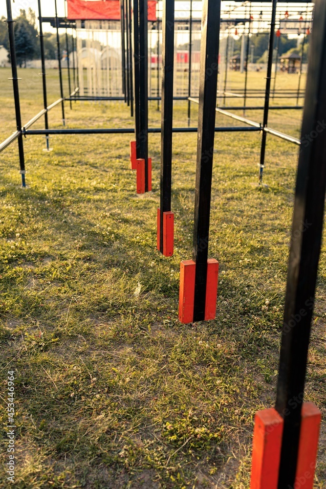 Obstacle course race ocr, hanging pendulum in a row, sunset Obstacle course race ocr, hanging pendulum in a row, sunset