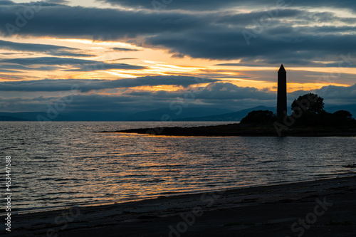 Silhouette of the Battle of Largs Pencil Monument at sunset, Largs, Scotland