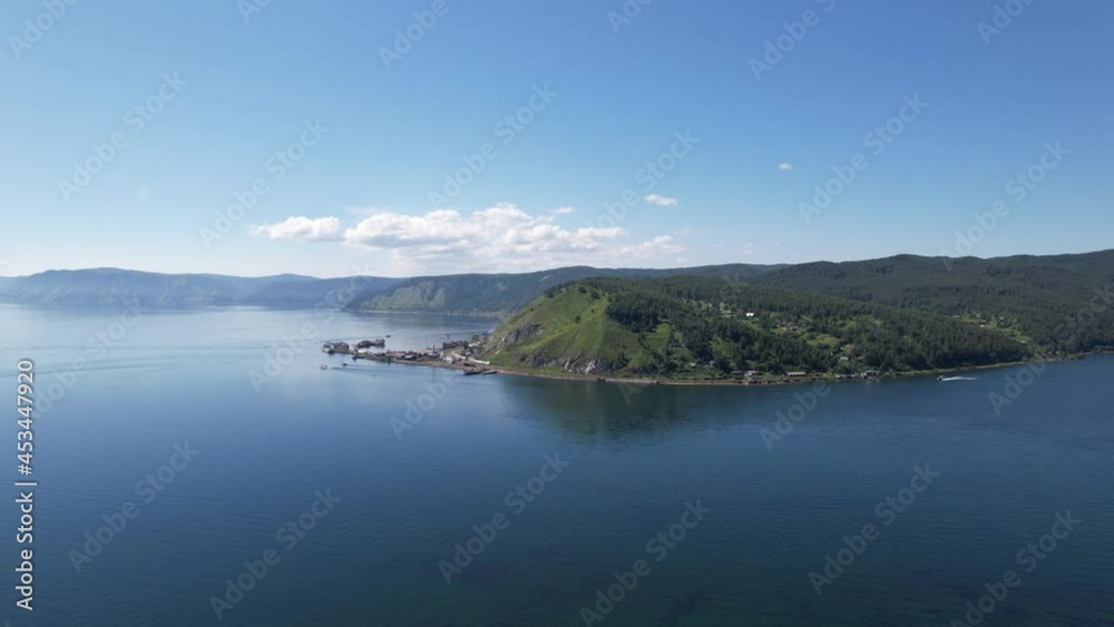The Angara River in Siberia leaving Lake Baikal near the settlement of Listvyanka. Panoramic aerial view. The Angara River in Siberia leaving Lake Baikal near the settlement of Listvyanka. Panoramic aerial view.