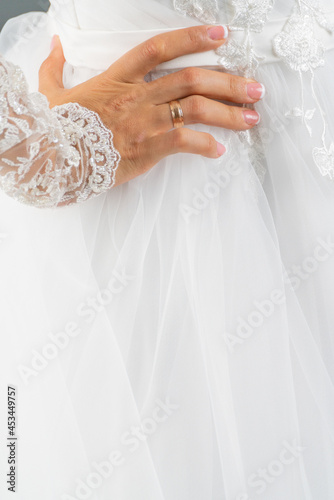 White dress of the bride. Light fabric texture. Traditional wedding wear.