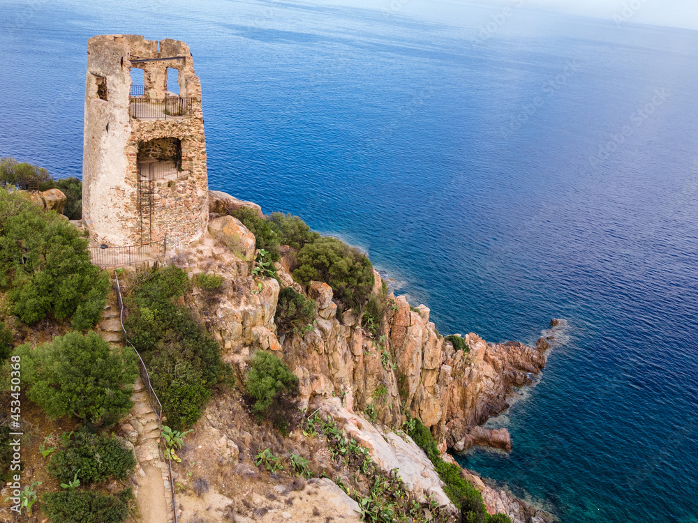 San Gemiliano tower on the rocky coast on the blue sea. Sardinia, Italy. City of Arbatax.