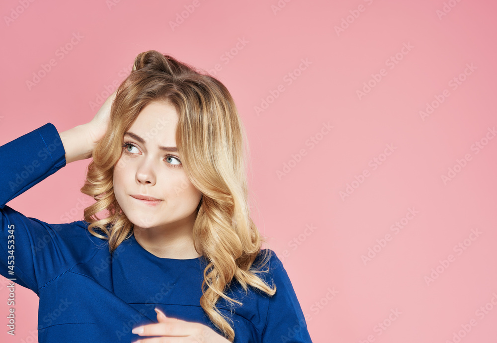 pretty blonde in blue dress holding hair studio pink background pretty blonde in blue dress holding hair studio pink background