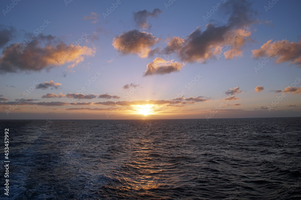 The magic of the ocean. Sunrise over the Atlantic. Horizon and endless space. Beautiful view. Clouds
