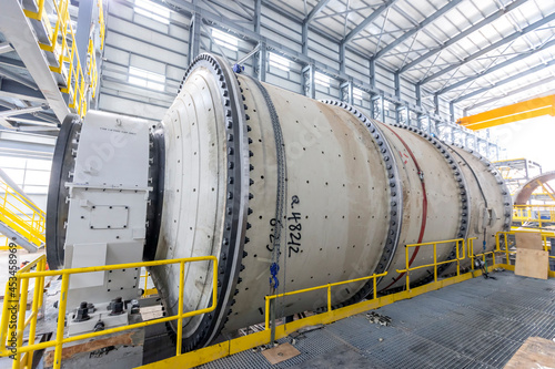 View of the large sag and ball mill in the mine factory. A ball mill is a type of grinder used to grind and blend materials for use in mineral dressing processes. photo