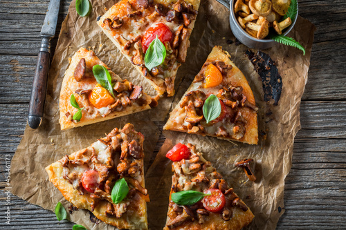 Tasty pizza with chanterelle mushrooms and vegetables. Forest mushroom pizza.
