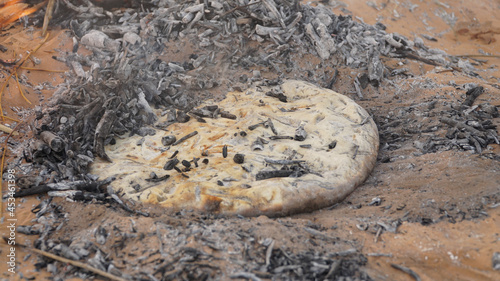 Sahara bread baking in the ground in the desert landscape of the Sahara Desert near Douz, Tunisia.