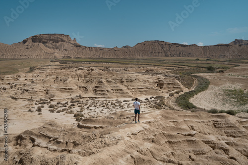 A man hiking in the desert of Bardenas Reales.