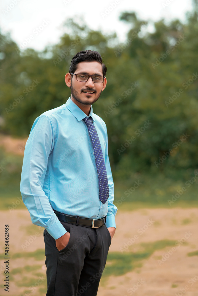Young indian agronomist giving expresssion over nature background Young indian agronomist giving expresssion over nature background