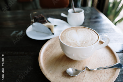 Foamed milk latte heart, Cup of hot coffee on the table in a cafe