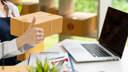 Start an Asian writing business working with parcel boxes at home with laptops to read orders and deliver products to customers. transport and logistics Online merchants and business owners or SMEs, o © ArLawKa
