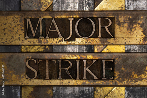 Major Strike text message on textured grunge copper and vintage gold background photo
