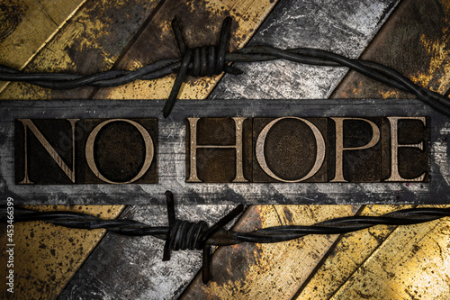 No Hope text on vintage grunge textured copper and gold background with barbed wire
