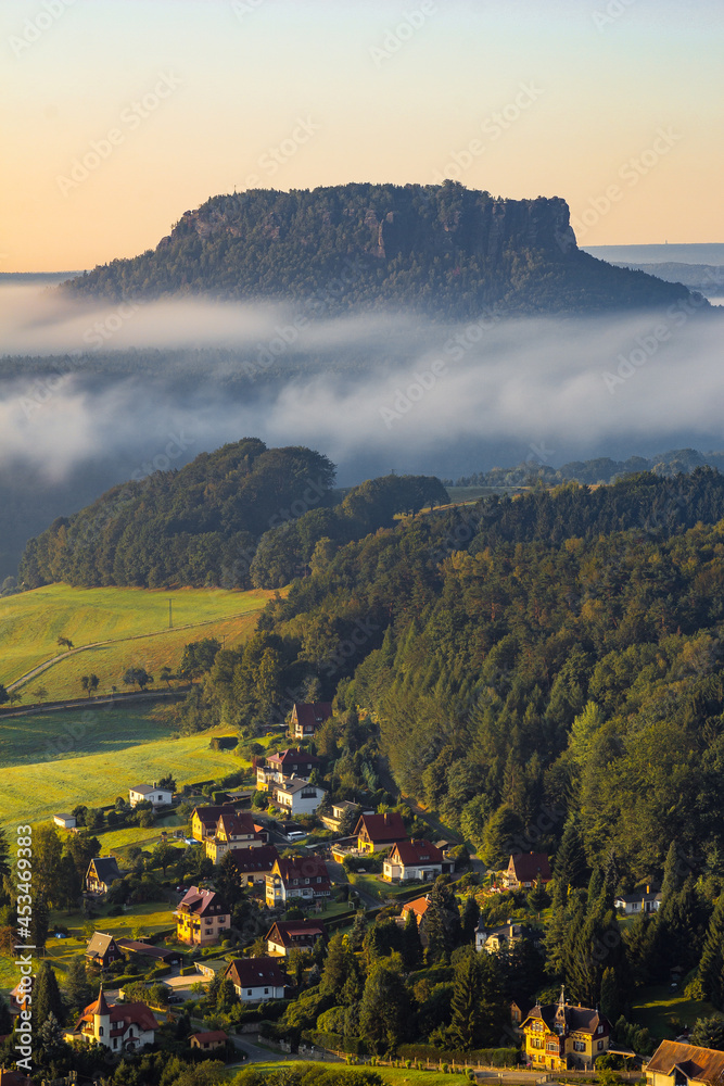 Table mountain Lilienstein during morning above clouds. Morning scenery.