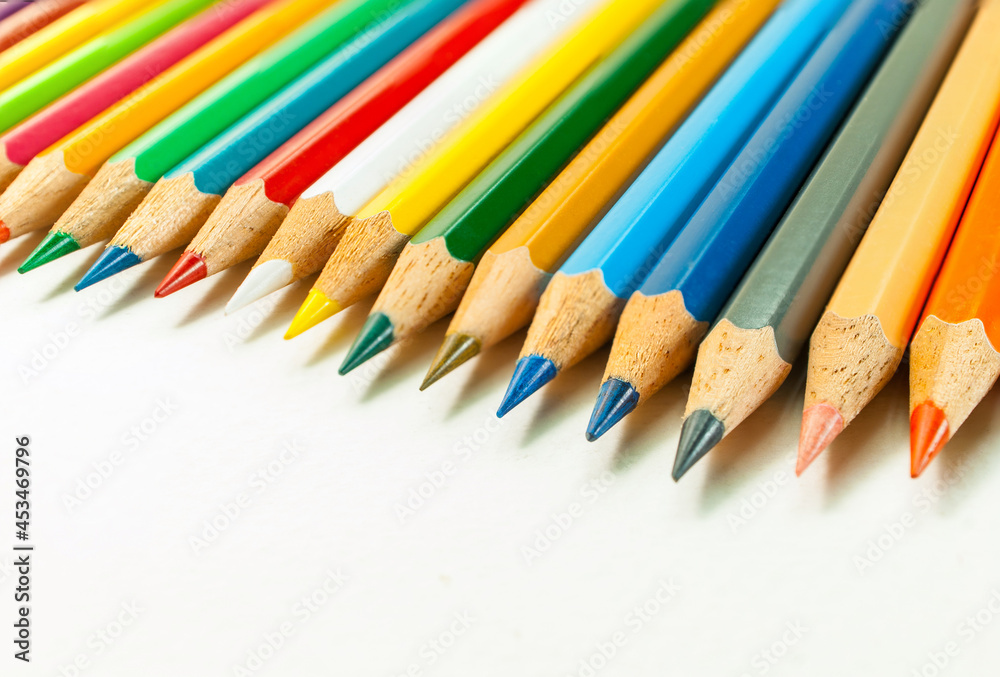 Front view image of various colored pencils. placed isolated on a white background and colored pencils in close-up.Concept art Text copy space and office Front view image of various colored pencils. placed isolated on a white background and colored pencils in close-up.Concept art Text copy space and office
