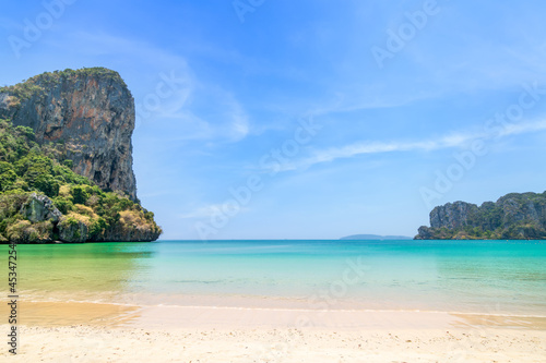 Railay beach west with crystal clear water and exotic landmark limestone cliff mountain, Krabi, Thailand © wirojsid