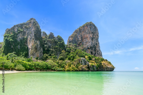 Railay beach west with crystal clear water and exotic landmark limestone cliff mountain, Krabi, Thailand