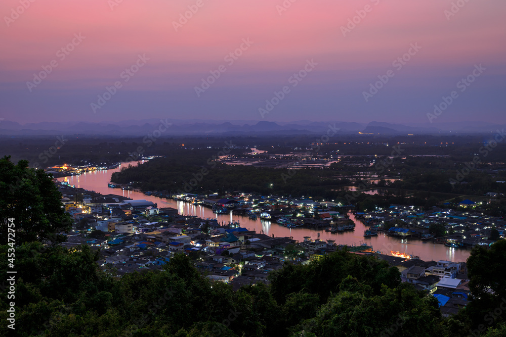 Obraz premium Pak Nam Chumphon town, fisherman village, and river from Khao Matsee scenic viewpoint during twilight, Thailand