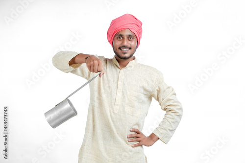 Indian milk man giving expression on white background.