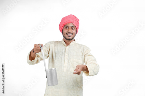 Indian milk man giving expression on white background.