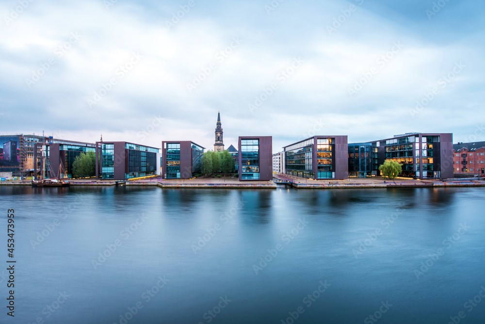 Breathtaking view with modern buildings and church spire on Copenhagen waterfront, Denmark. Exotic amazing places. Popular tourist atraction.