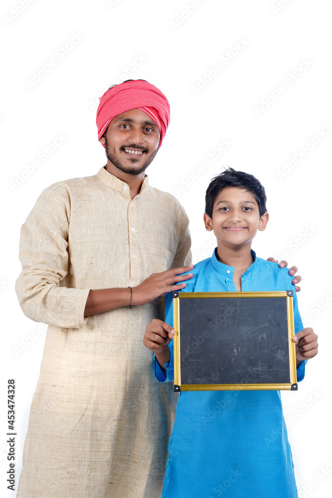 Education concept : Indian farmer with his child showing blank chalkboard on white background. Education concept : Indian farmer with his child showing blank chalkboard on white background.