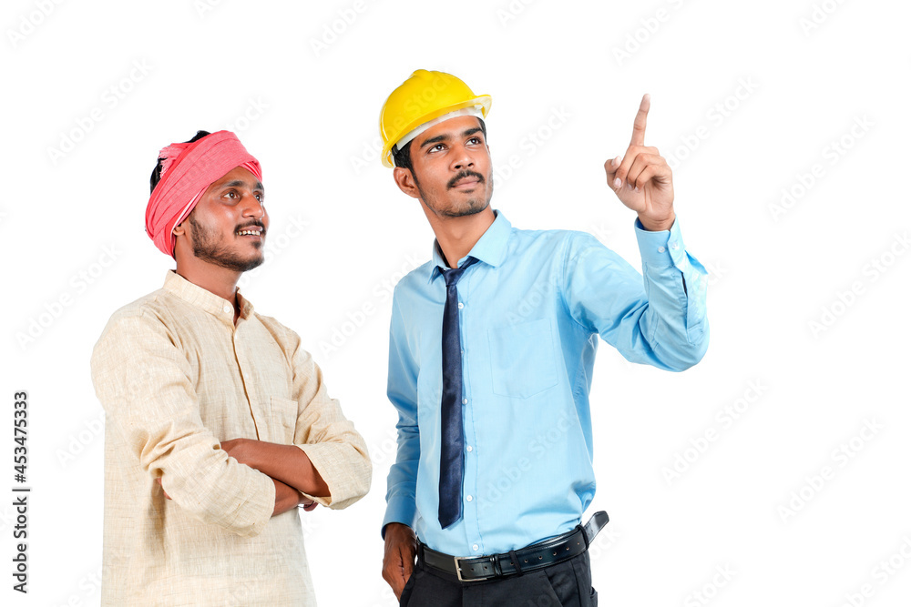 Young indian engineer with farmer on white background. Young indian engineer with farmer on white background.