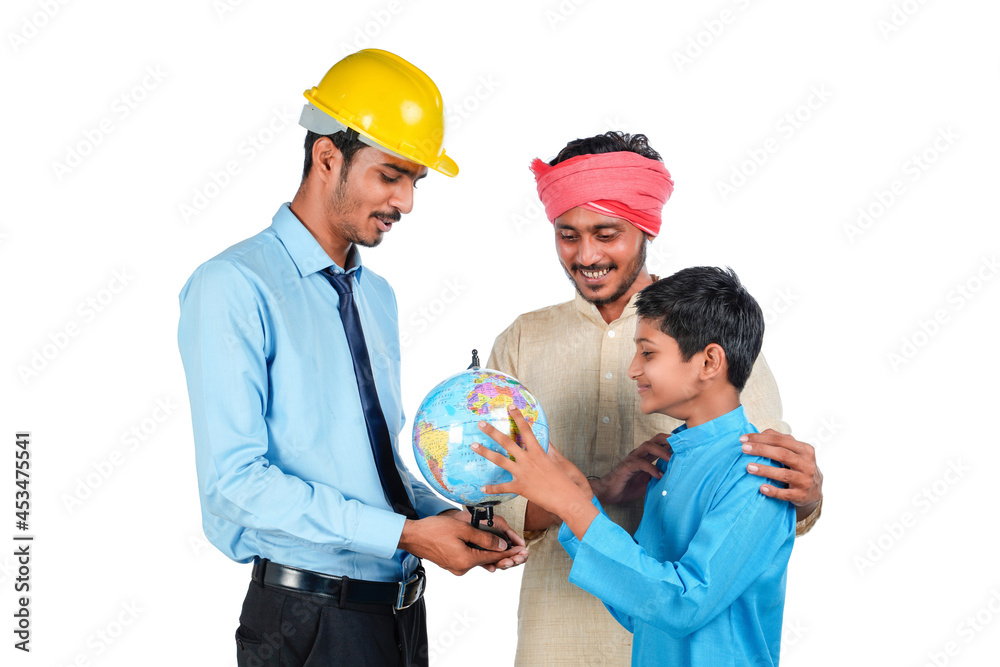 Young indian engineer showing some detail to farmer and his child in world globe map. Young indian engineer showing some detail to farmer and his child in world globe map.