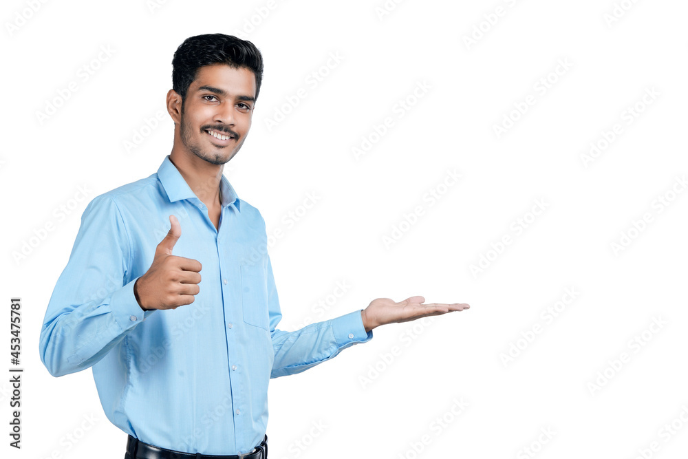 Young indian man showing expression on white background Young indian man showing expression on white background