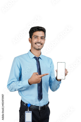 Young indian officer or student showing smartphone screen on white background.