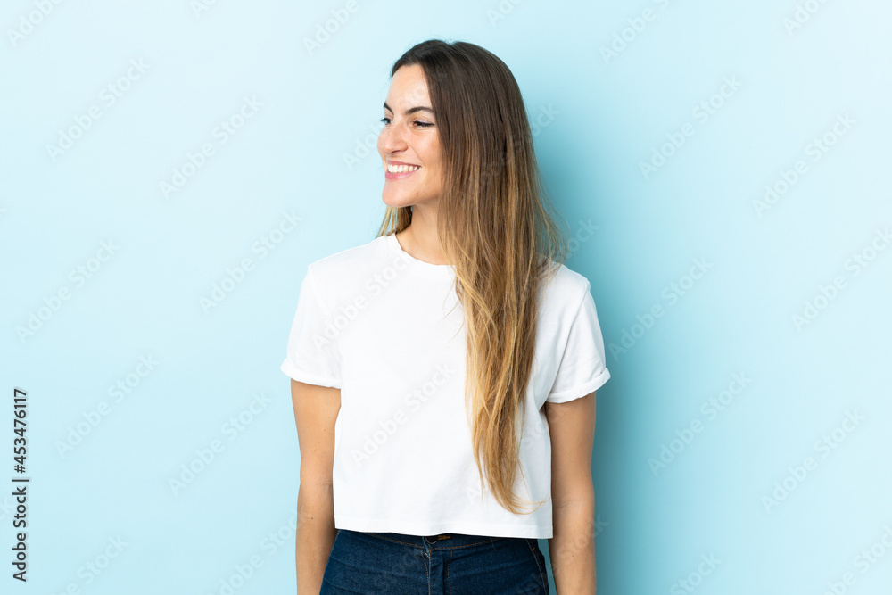 Young caucasian woman over isolated background looking side Young caucasian woman over isolated background looking side