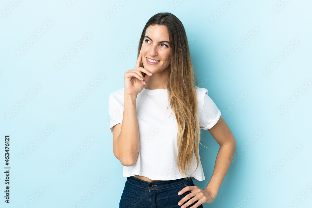 Young caucasian woman over isolated background thinking an idea while looking up Young caucasian woman over isolated background thinking an idea while looking up