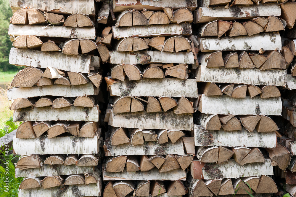Birch firewood stacked in rows front view Birch firewood stacked in rows front view