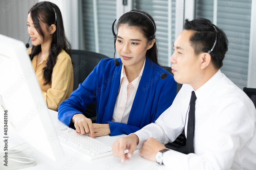 woman operator training and suggesting about work with colleagues at call center service woman operator training and suggesting about work with colleagues at call center service