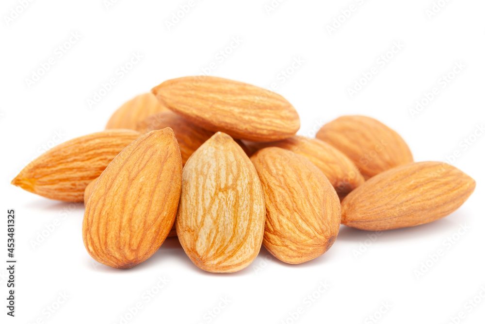 Micro close-up and details of Organic Indian brown almonds (Prunus dulcis) kernels isolated over white background. Micro close-up and details of Organic Indian brown almonds (Prunus dulcis) kernels isolated over white background.