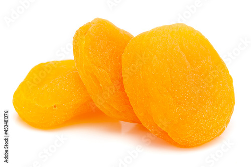 Micro close-up and details of Organic orange colored dried three apricot (prunus armeniaca)  isolated over white background.