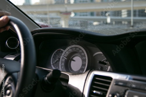 Driving a Car with Dashboard Speedometer in Front of the Steering Wheel