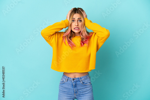 Young woman over isolated blue background doing nervous gesture