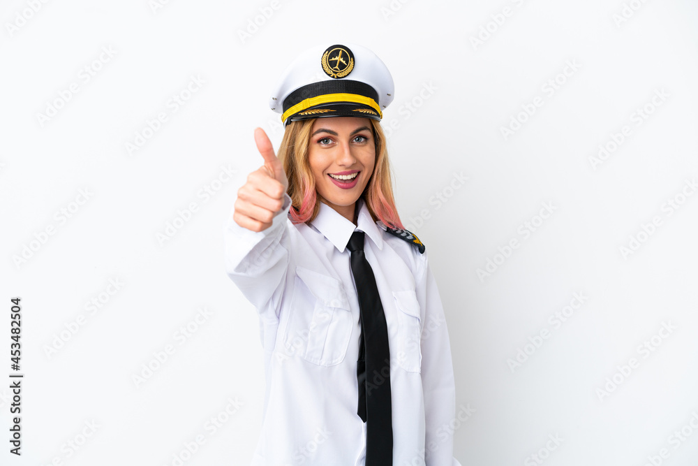 Airplane pilot over isolated white background with thumbs up because something good has happened Airplane pilot over isolated white background with thumbs up because something good has happened