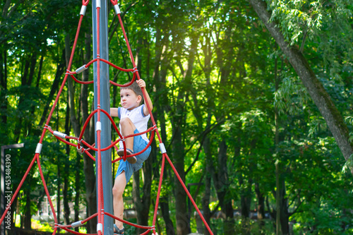 Kid practicing rope climbing in a city park