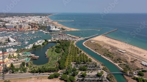 Aerial video of the tourist Portuguese town of Vilamoura, with views of the beaches and docks for luxury yachts, hotels and restaurants. Portugal, Algarve.