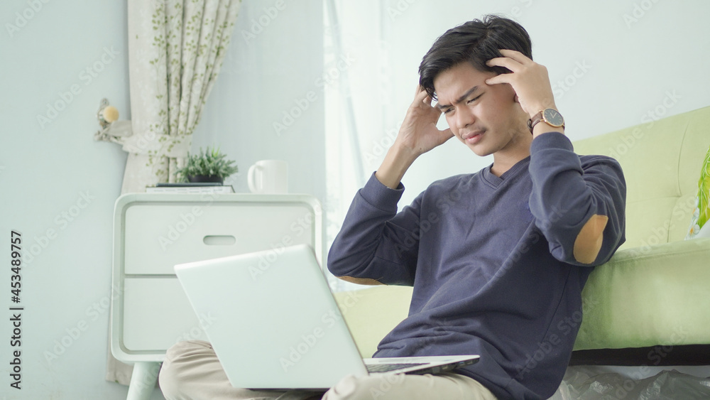 handsome man is stressed because of working from home handsome man is stressed because of working from home