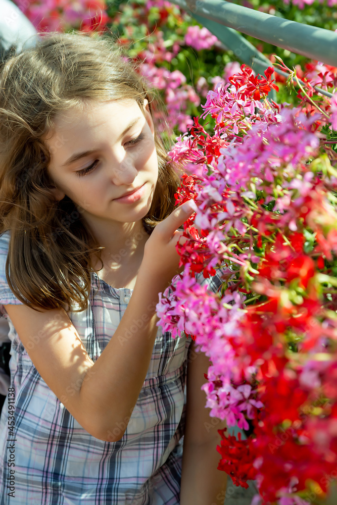 cute beautiful, natural teen girl sniffing Phlox adsurgens Wagon Wheels on sunny day cute beautiful, natural teen girl sniffing Phlox adsurgens Wagon Wheels on sunny day