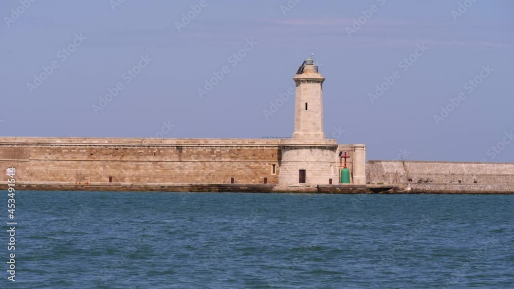 White Stone Lighthouse and Blue Sea - slow motion White Stone Lighthouse and Blue Sea - slow motion