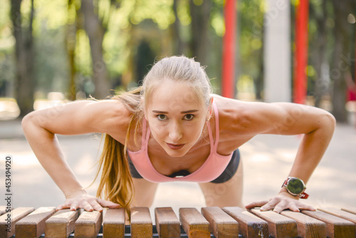 young sportive woman goes in for sports in the park. outdoor fitness, healthy lifestyle