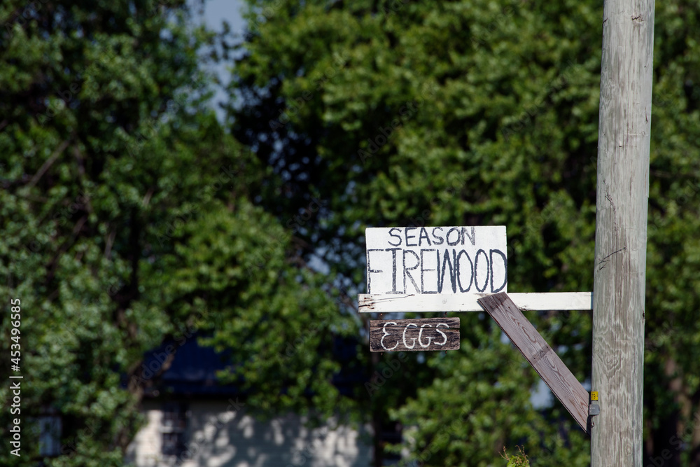 Rural Farm sign advertising eggs and firewood for sale.