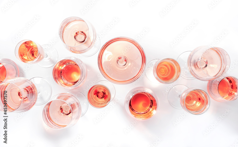 Rose wine glasses on white background. Wine tasting, top view, negative space Rose wine glasses on white background. Wine tasting, top view, negative space